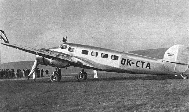 Lockheed Model 10 Electra on the ground in a black-and-white airport photograph, showing the twin-engine transport aircraft from Lockheed's prewar civil-aircraft line.