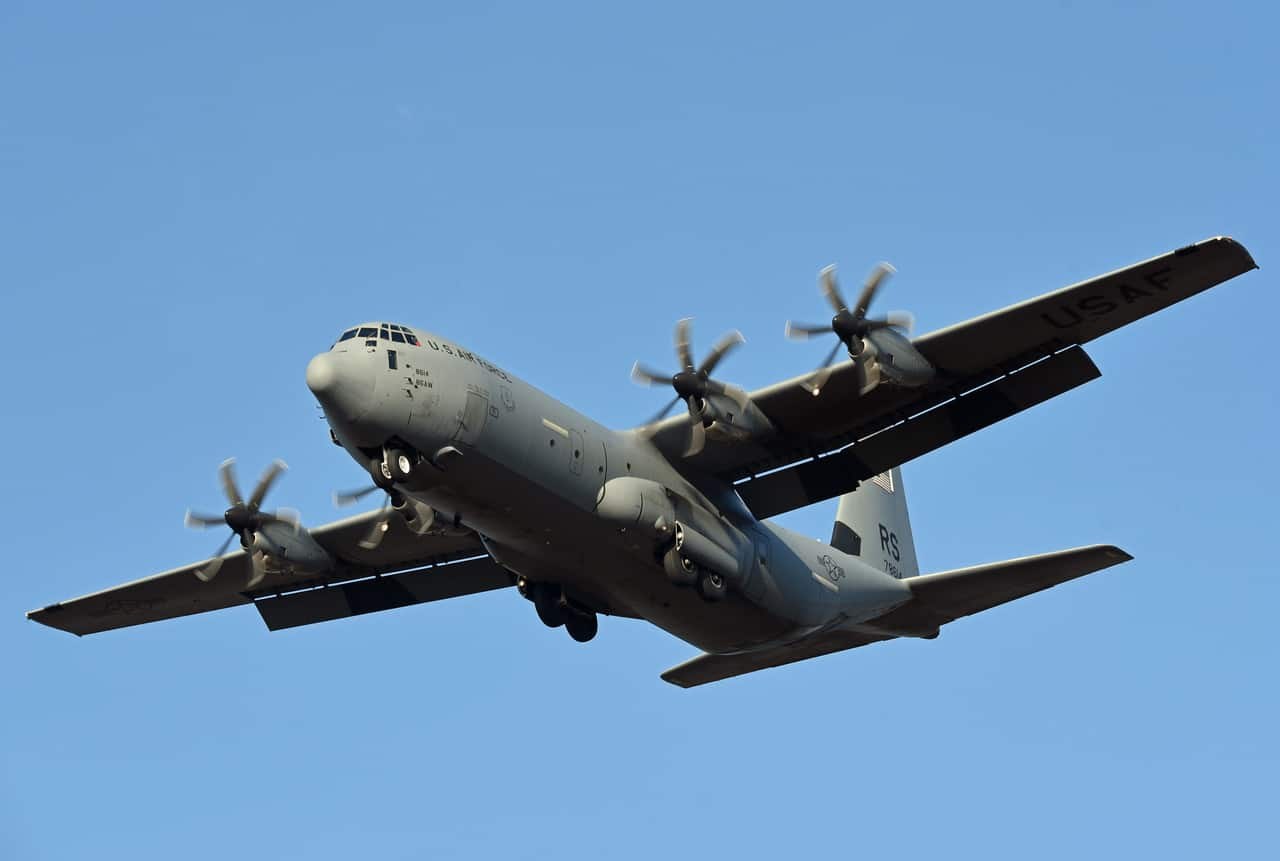 C-130J Super Hercules climbing with all four propellers blurred.