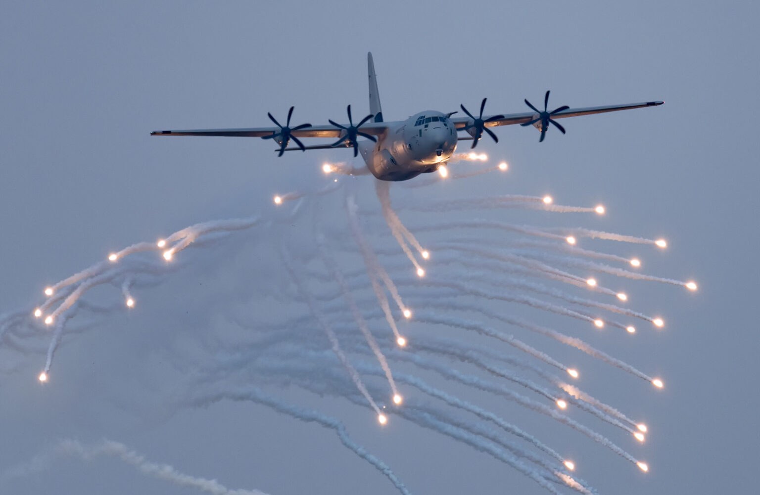 C-130J Super Hercules releasing bright flares in flight.