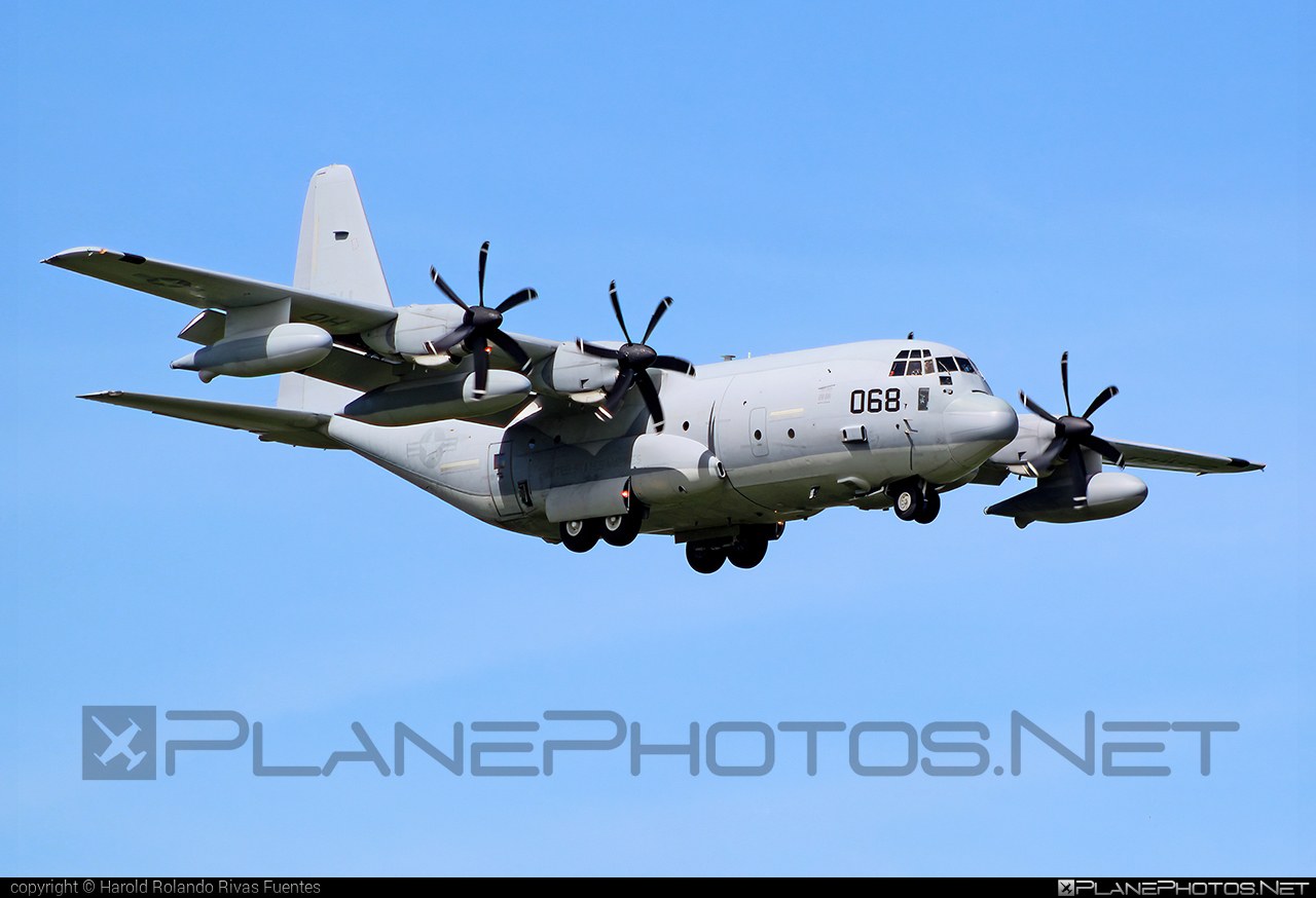 Marine KC-130J 068 flying with underwing pods and propellers turning.