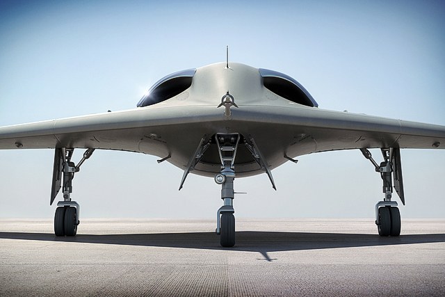 Frontal rendering of an RQ-170 Sentinel with landing gear extended on a runway.