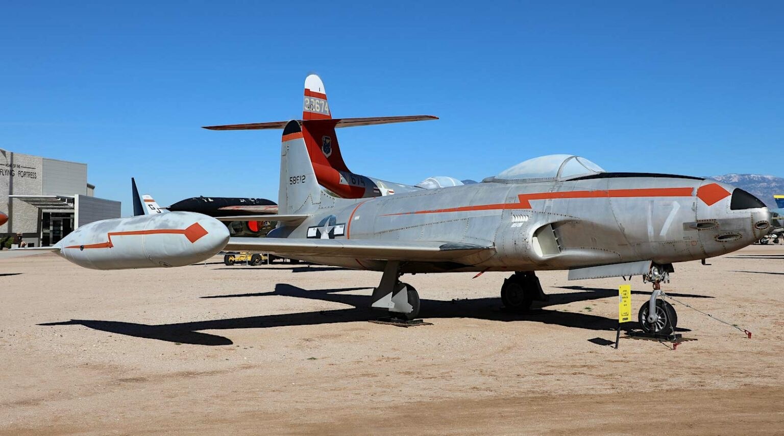 Silver P-80 Shooting Star displayed outdoors on a desert ramp.