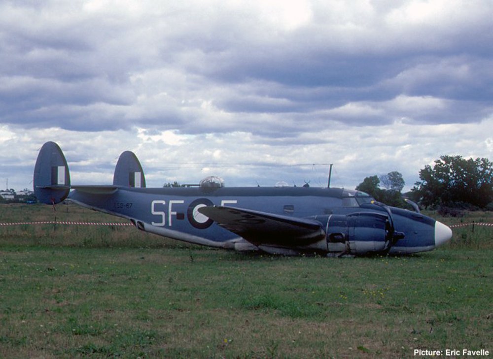 PV-1 Ventura marked 5F resting on grass under cloudy sky.