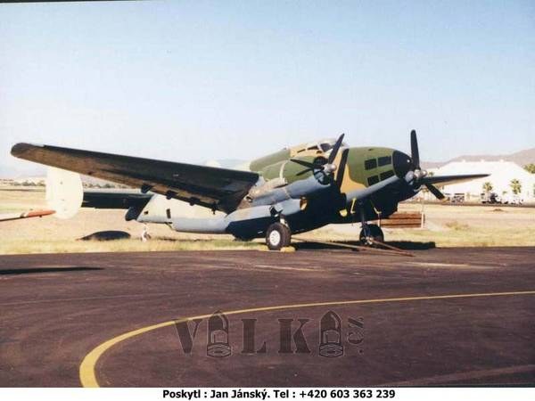 Camouflaged PV-1 Ventura parked on a ramp with twin engines and twin tails visible.