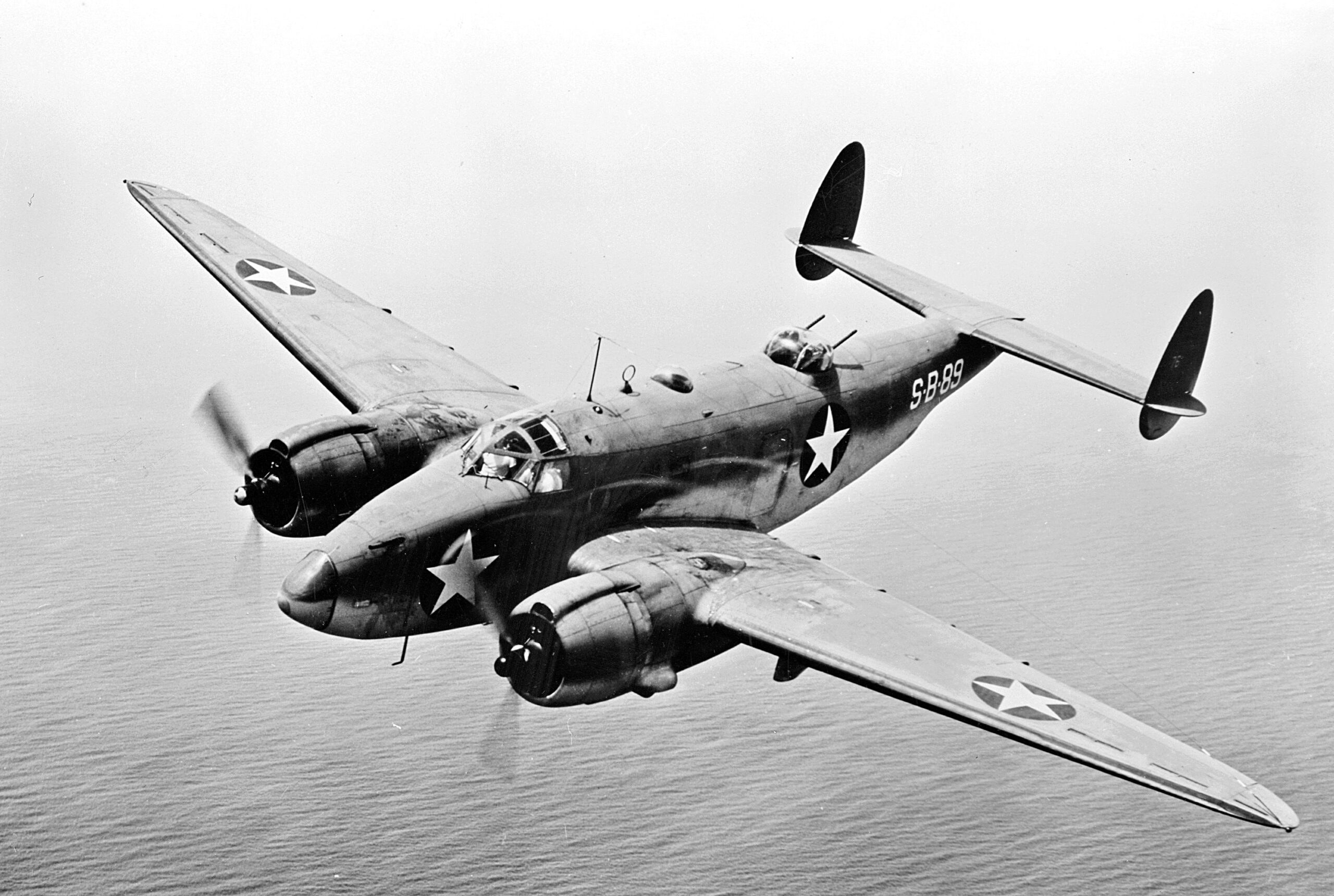 Black-and-white view of PV-2 Harpoon 5299 banking in flight.