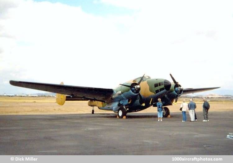 Camouflaged PV-2 Harpoon parked on a ramp with people nearby.