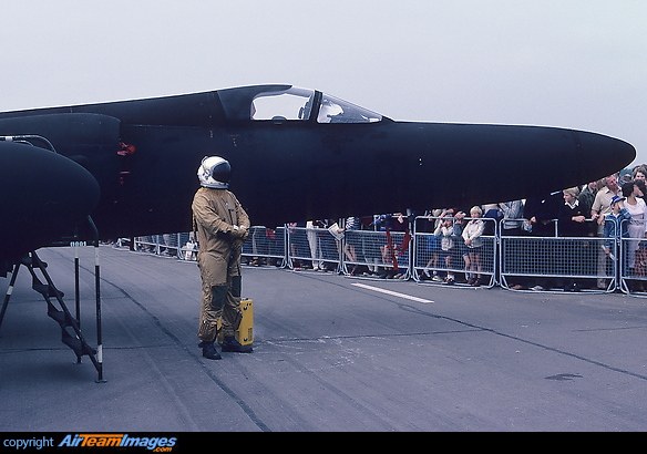 Black U-2 nose section on display with a suited pilot standing nearby.