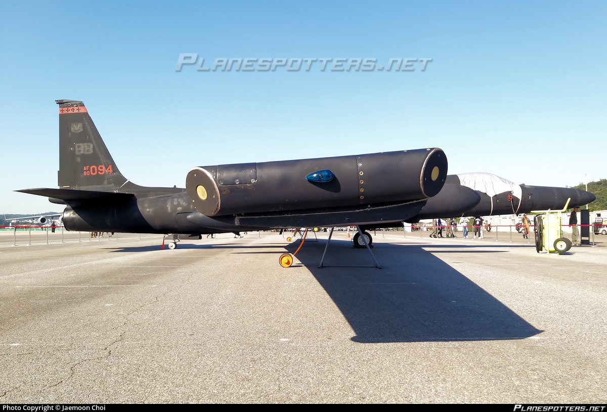 Black U-2 1094 parked in side view with long wing and tail markings visible.