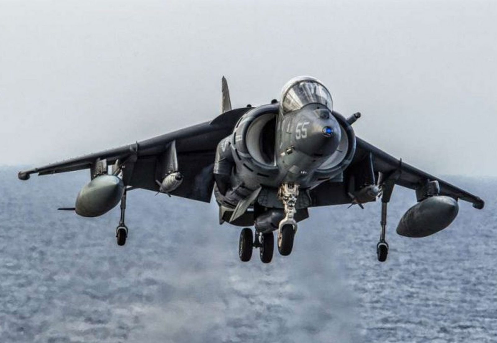 AV-8B Harrier II 55 approaching head-on over water with landing gear down.
