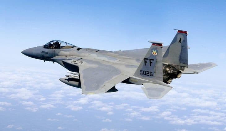 F-15 Eagle FF 1026 flying above clouds in side view.