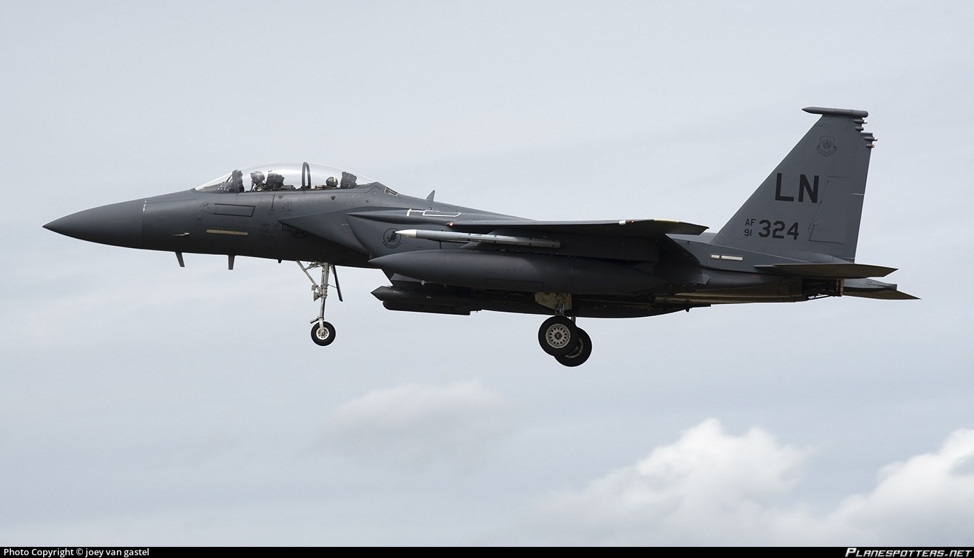 F-15E Strike Eagle marked LN 91-0324 approaching with landing gear down.