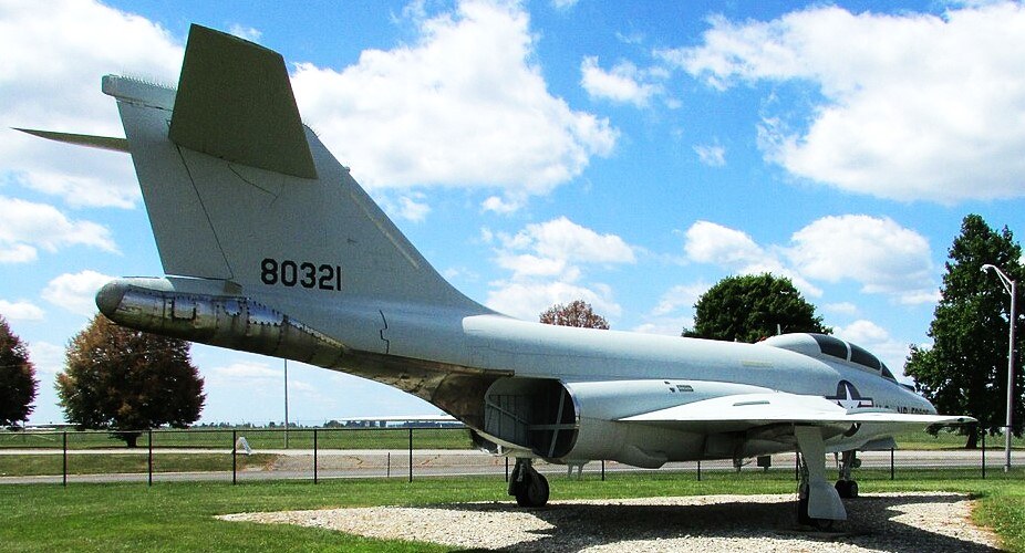 Light gray F-101 Voodoo numbered 80321 displayed outdoors on a grass and gravel pad.