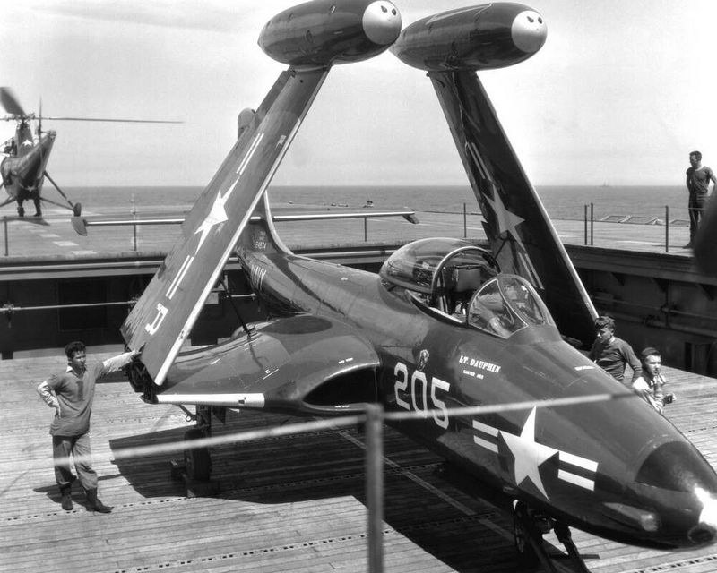 U.S. Navy F2H Banshee numbered 205 on an aircraft carrier deck with wings folded.