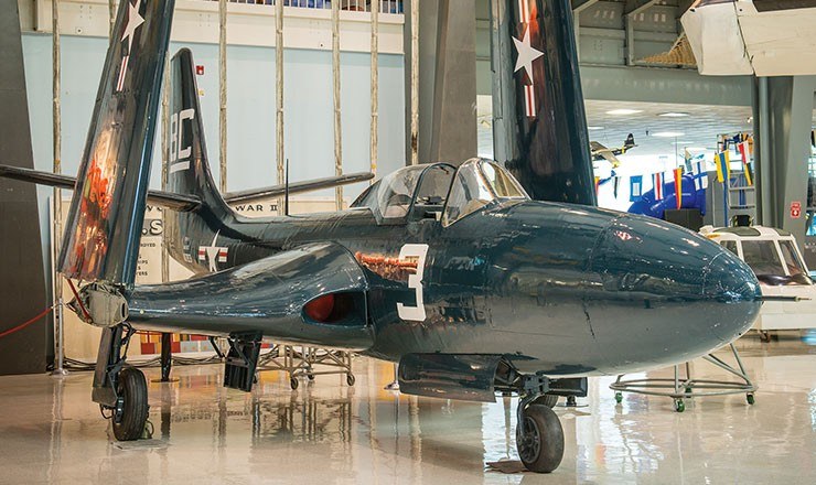 Front three-quarter view of McDonnell FH Phantom number 3 displayed indoors.