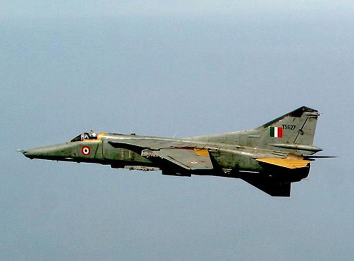 MiG-27 marked TS627 flying side-on with landing gear retracted.