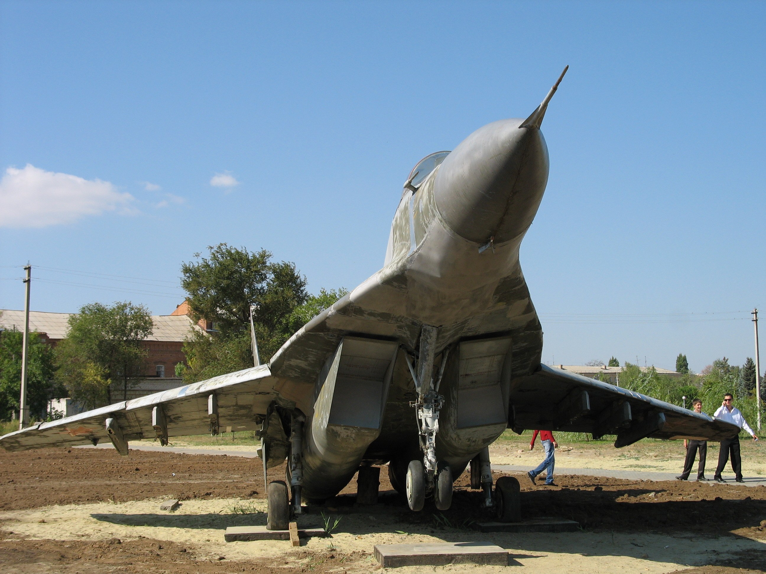 Front view of a MiG-29 displayed outdoors with landing gear down.