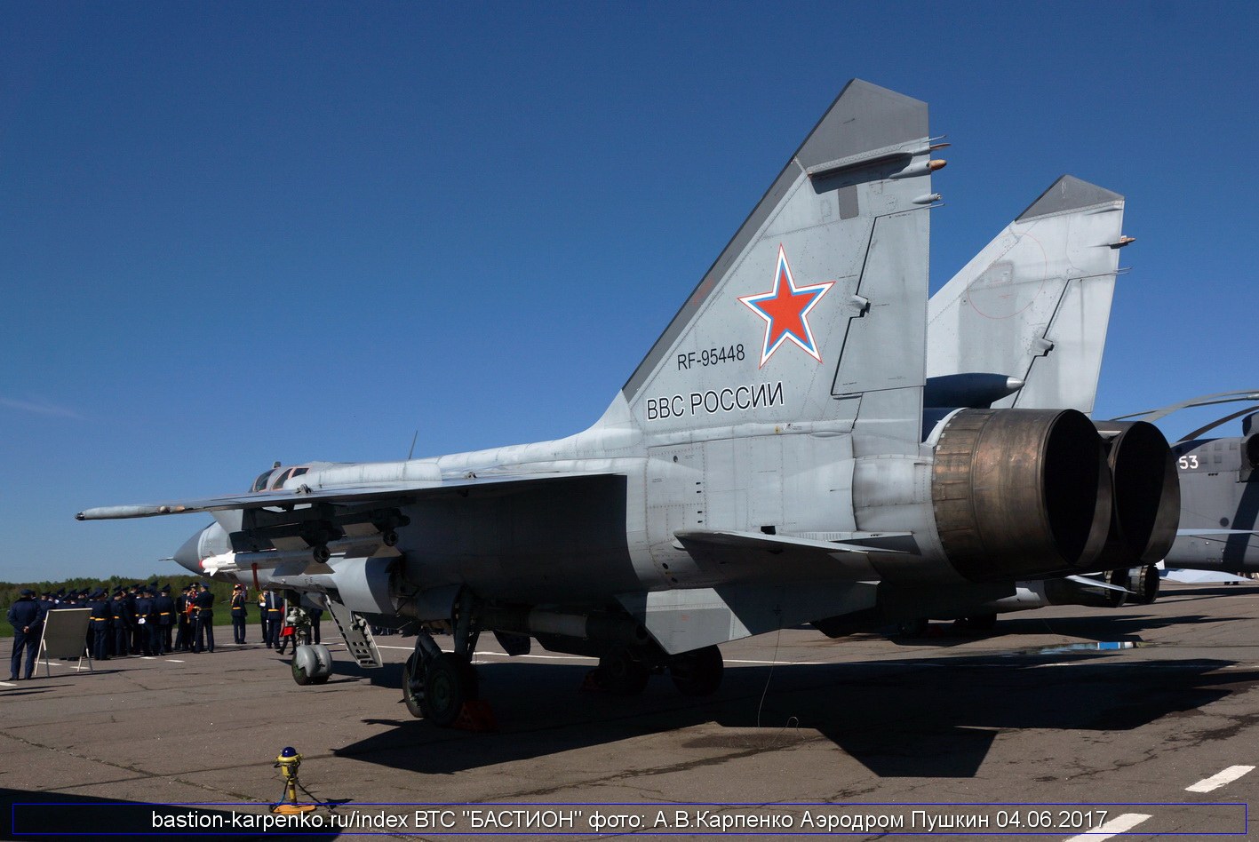 Rear three-quarter view of MiG-31 RF-95446 parked on a ramp with red star tail marking.