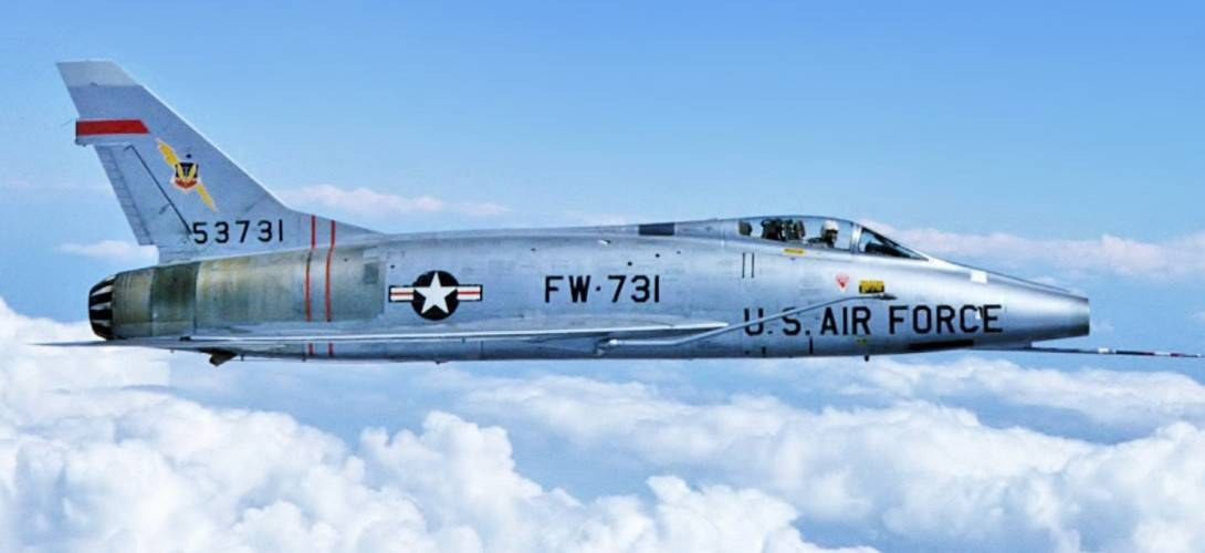 U.S. Air Force F-100 Super Sabre FW-731 flying side-on above clouds.