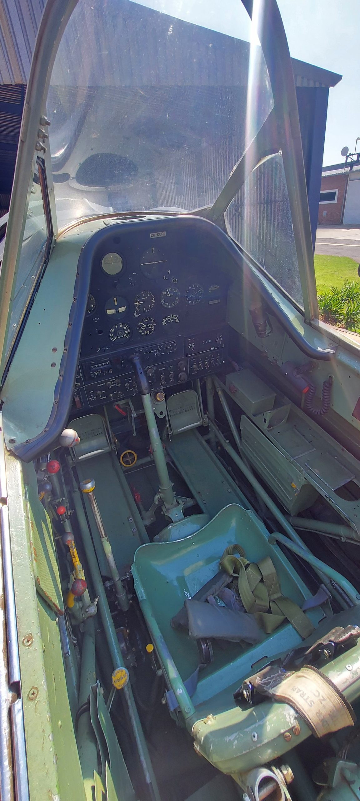 Open cockpit view of a North American Harvard showing instrument panel and seat.