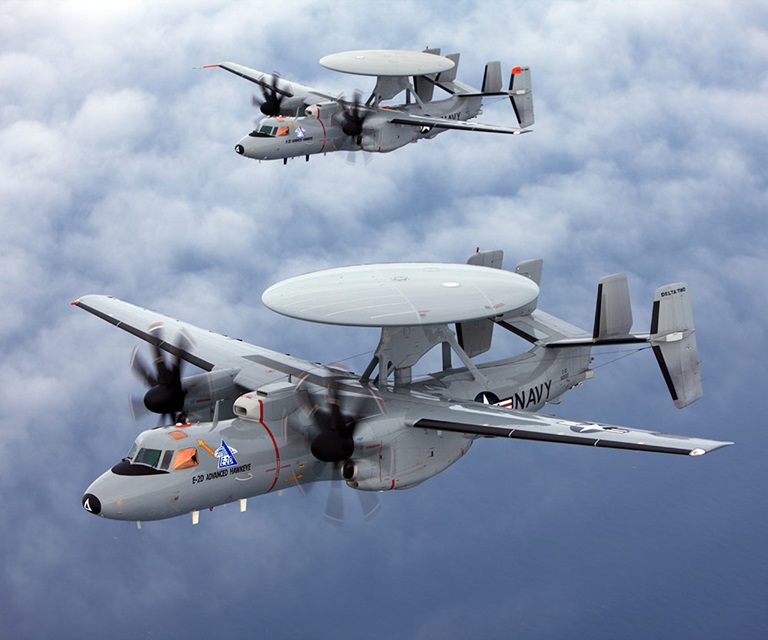 Two E-2D Advanced Hawkeye aircraft flying above clouds