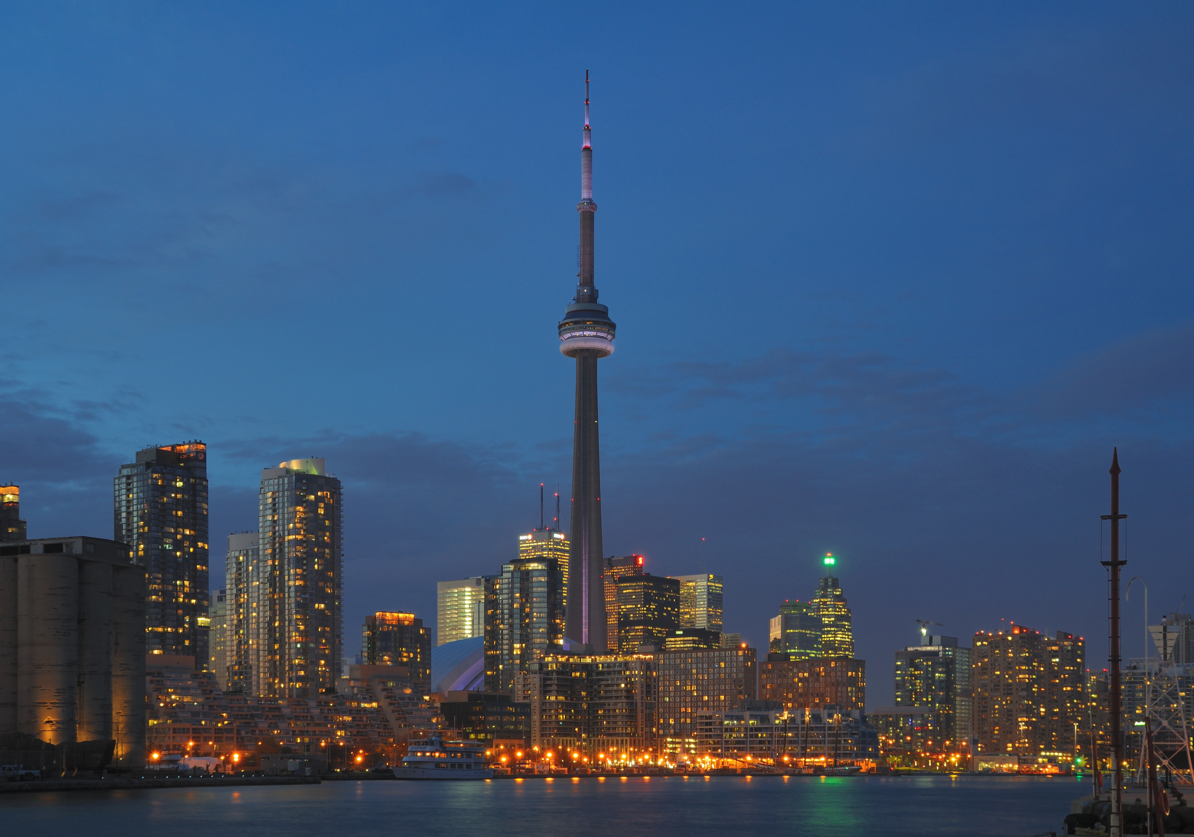 Toronto skyline at night, showing Canada through modern settlement and urban infrastructure.