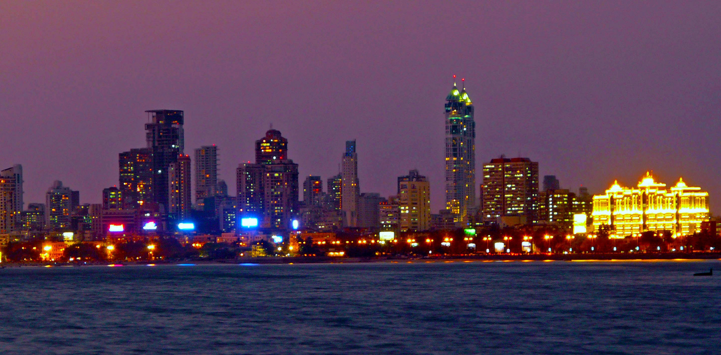 Mumbai skyline at night, showing India through modern settlement and urban infrastructure.