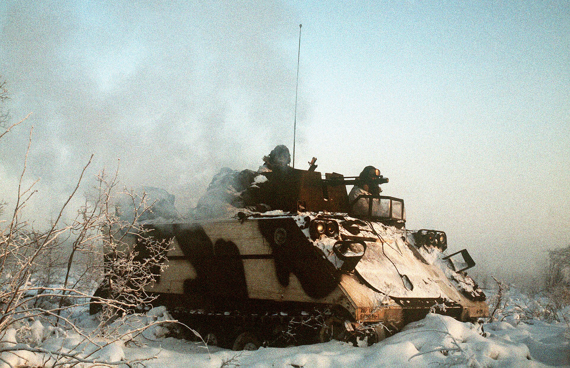 An M113 armored personnel carrier moves into action during Exercise BRIM FROST 89 DA-ST-90-01587.