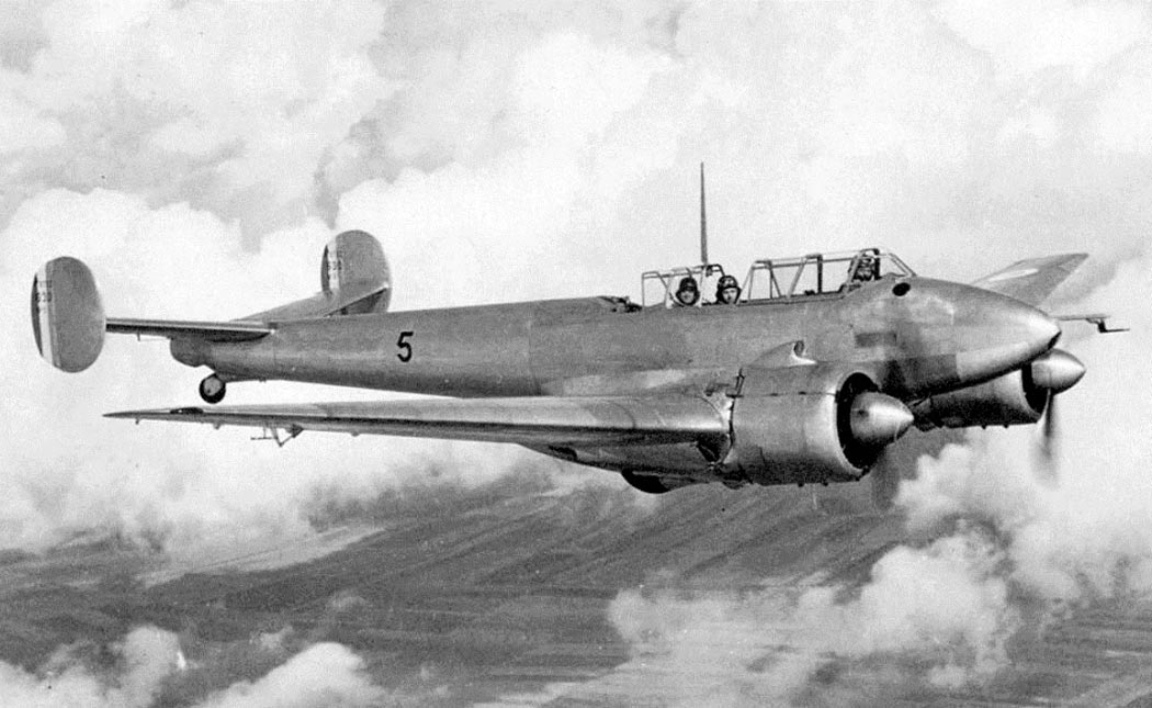 Potez 63 twin-engine aircraft in flight near clouds