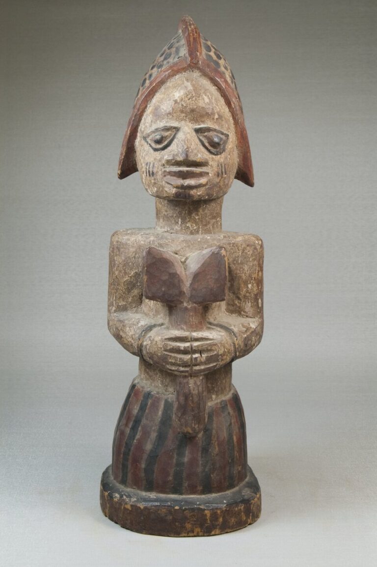 Devotee of Shango holding a ritual emblem