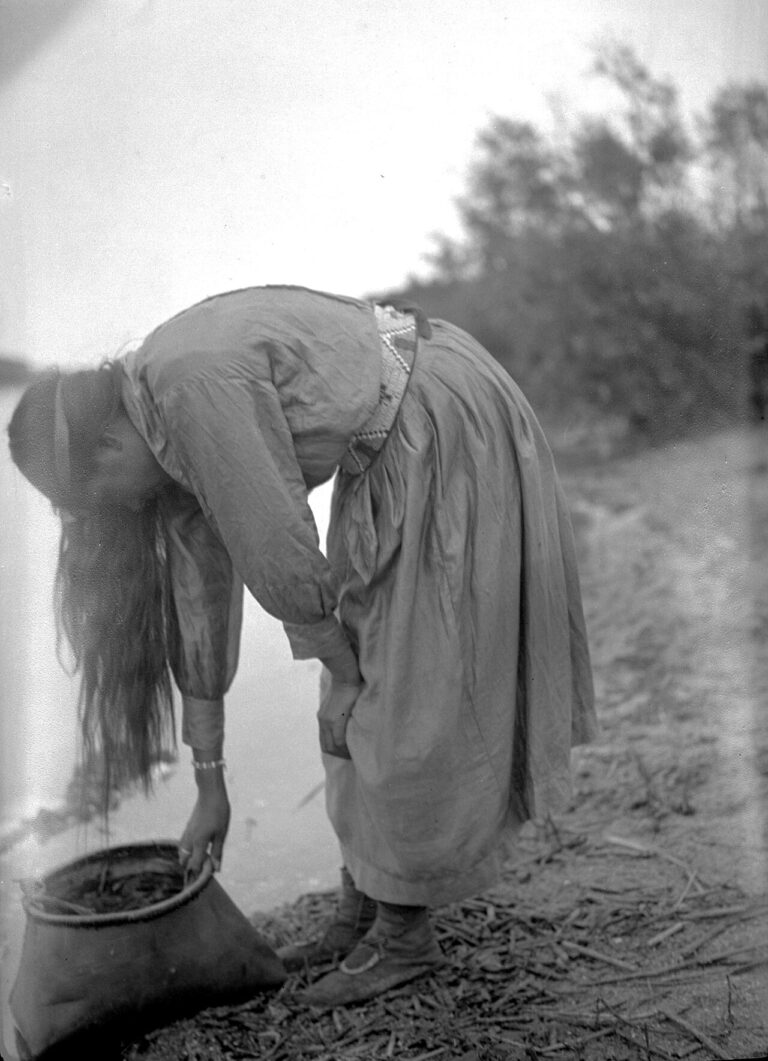 Cree woman with birch-bark container