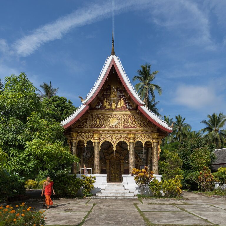 Vat Pa Phai temple with a Buddhist monk, orange marigold