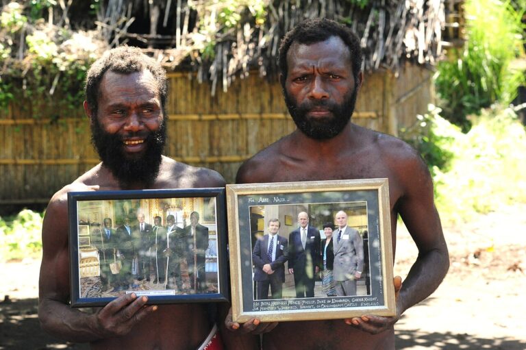 Yaohnanen villagers with photographs of Prince Philip
