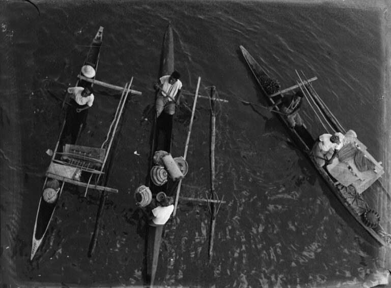 (Elevated view of three Pacific Island canoes)