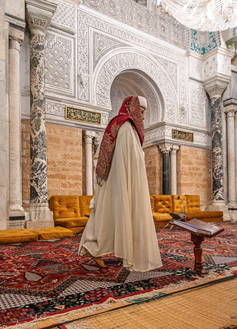 Imam standing at the mihrab in Zitouna Mosque