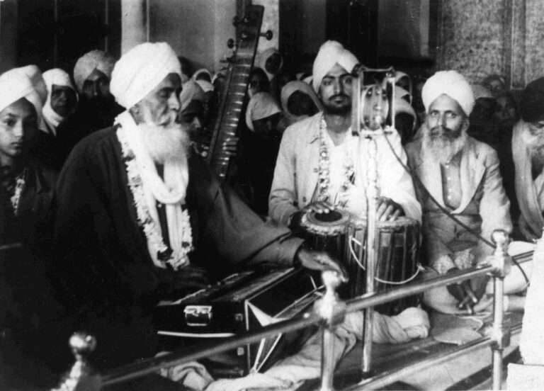 Photograph of Bhai Jawala Singh Ragi playing accordion (vaaja), Bhai Gurcharn Sing