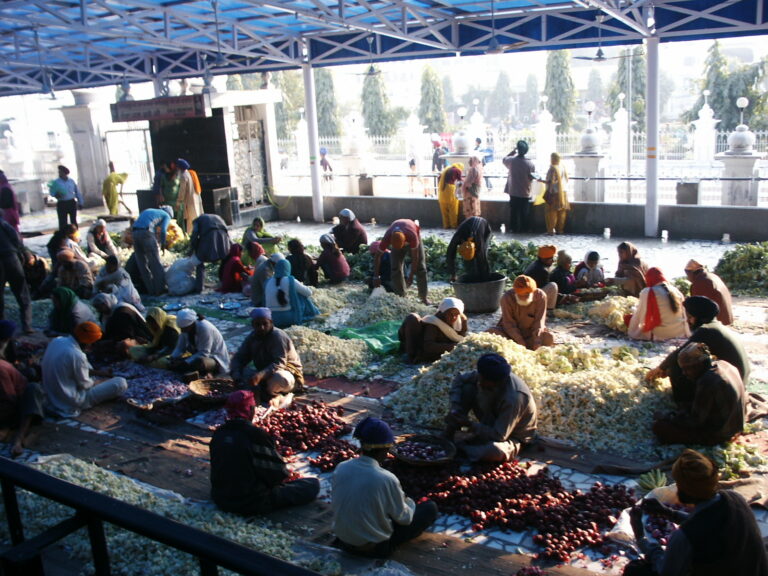 A group of volunteers helping with daily food preparation for Langar at the Golden