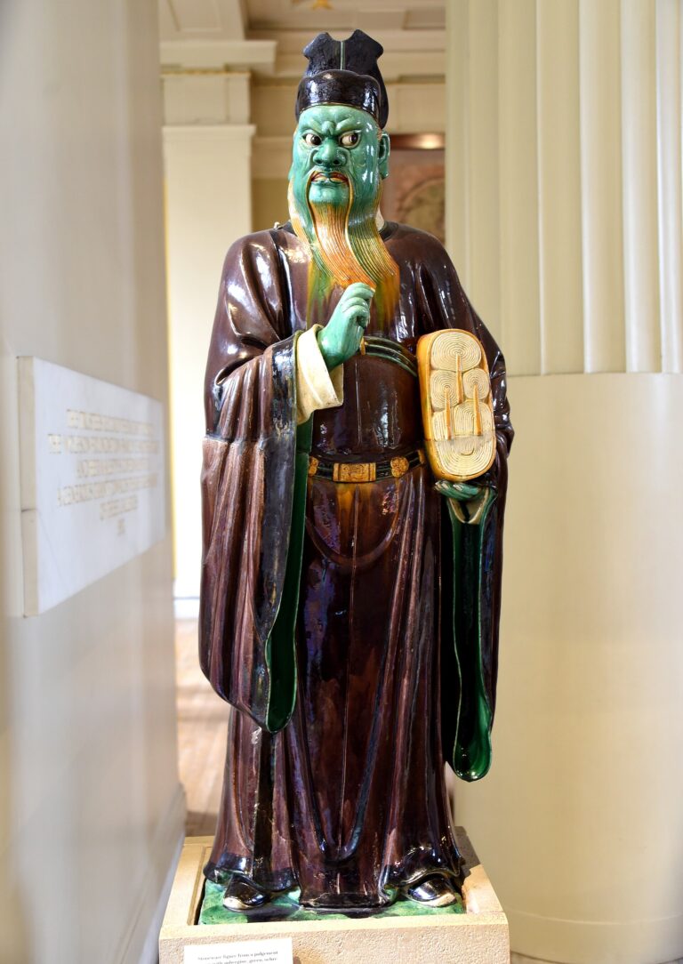 Ming stoneware judge figure holding records of evil deeds