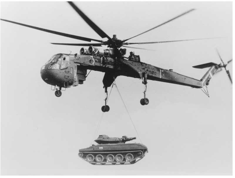 Sikorsky CH-54 Skycrane lifting a vehicle sling load, showing the specialized heavy-lift helicopter's external-cargo role.