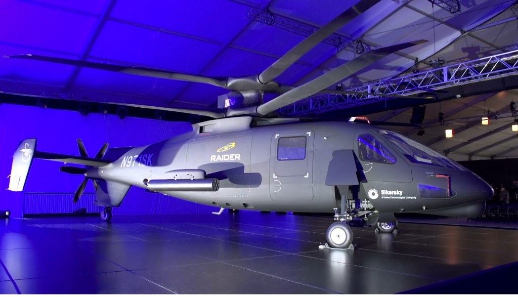 Sikorsky S-97 Raider N971SK displayed indoors under blue lighting.