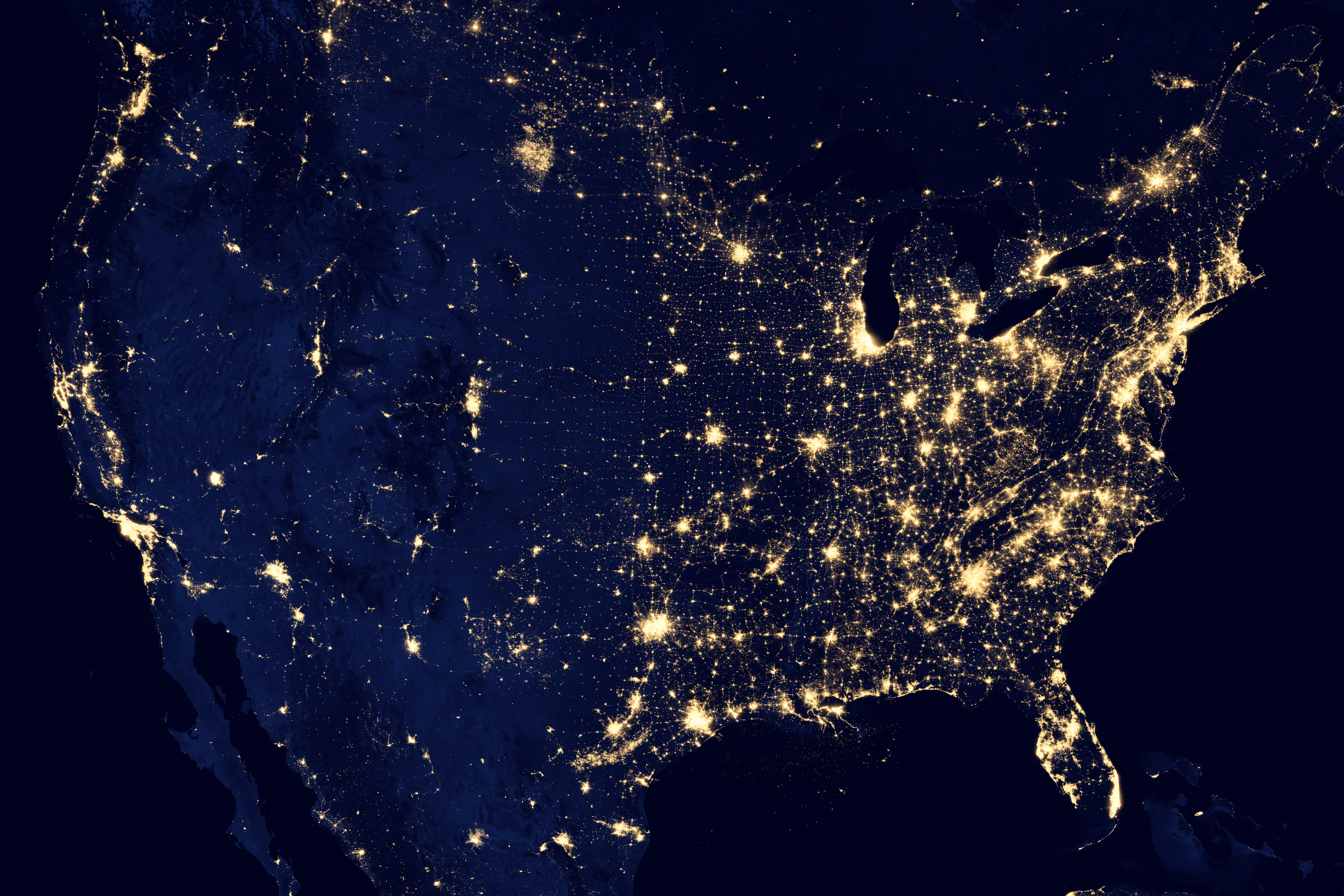 Nighttime satellite view of United States city lights, showing the faction through its modern settlement and infrastructure pattern.