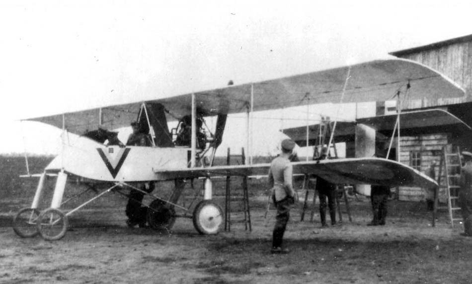 Voisin III pusher aircraft ground view beside a hangar