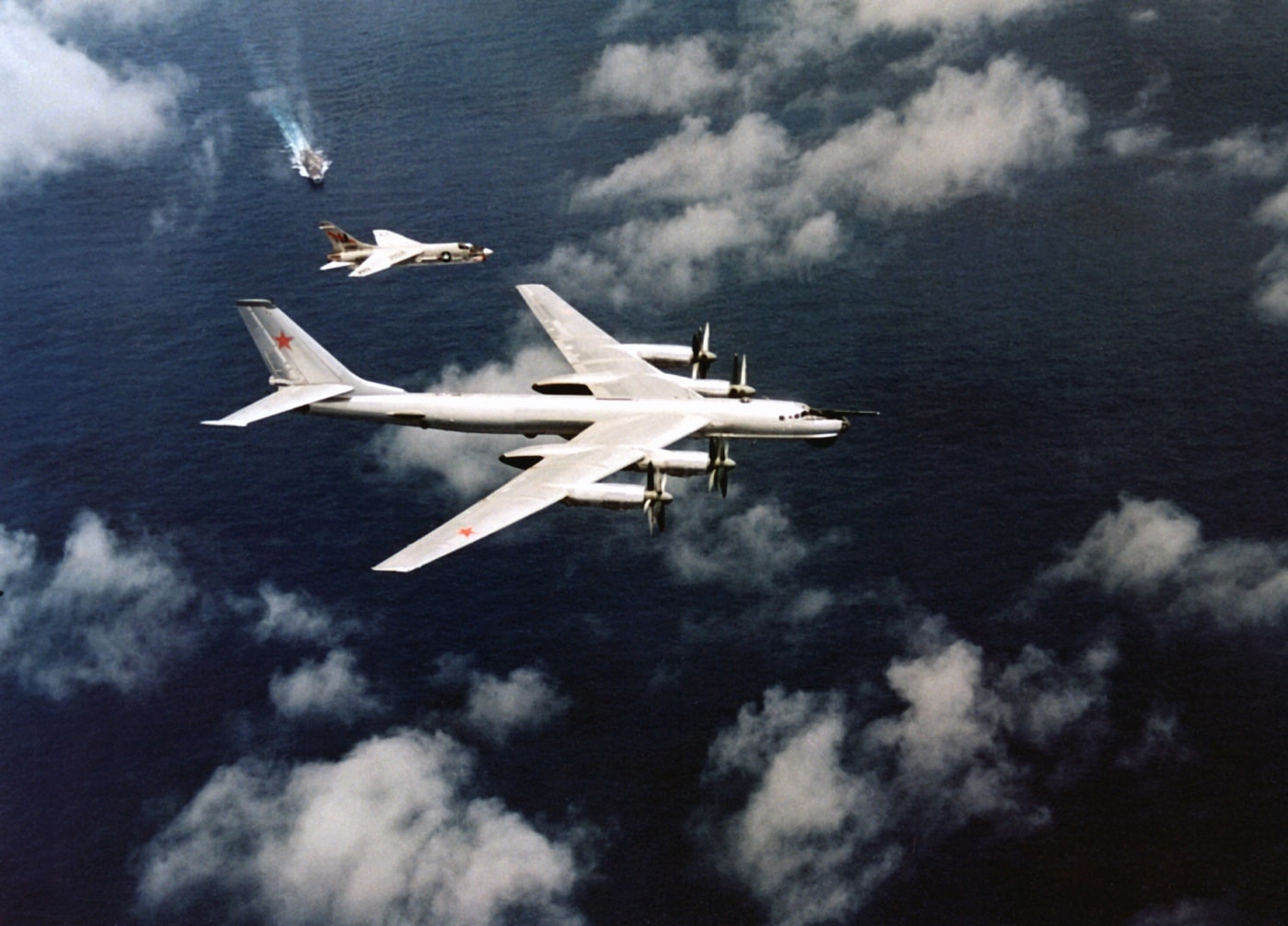 Vought F-8 Crusader - In this photo, an F8U Crusader escorts a Soviet Union TU-95 Bear bomber away from a U.S. Navy carrier group during the Cold War. The Crus...