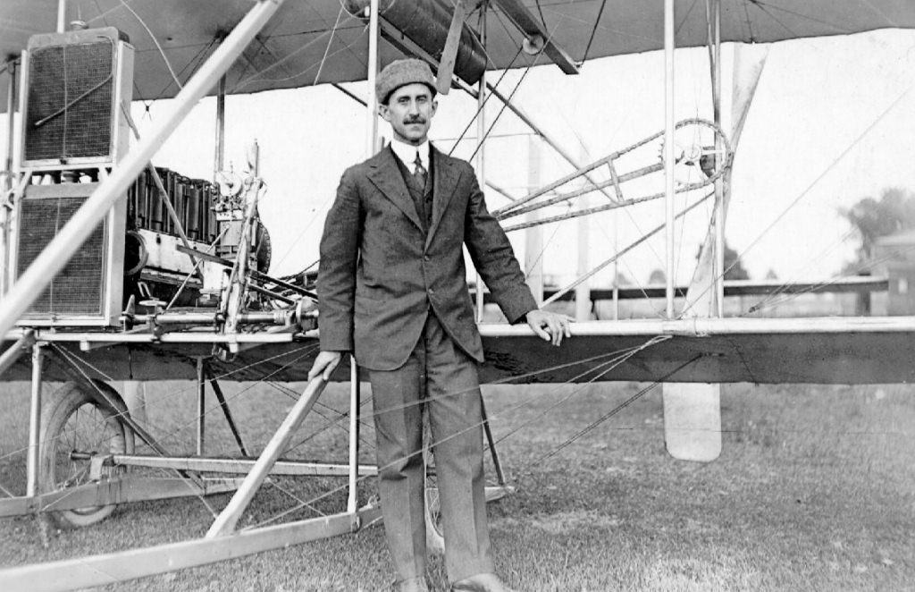Orville Wright standing beside a Wright Model C aircraft